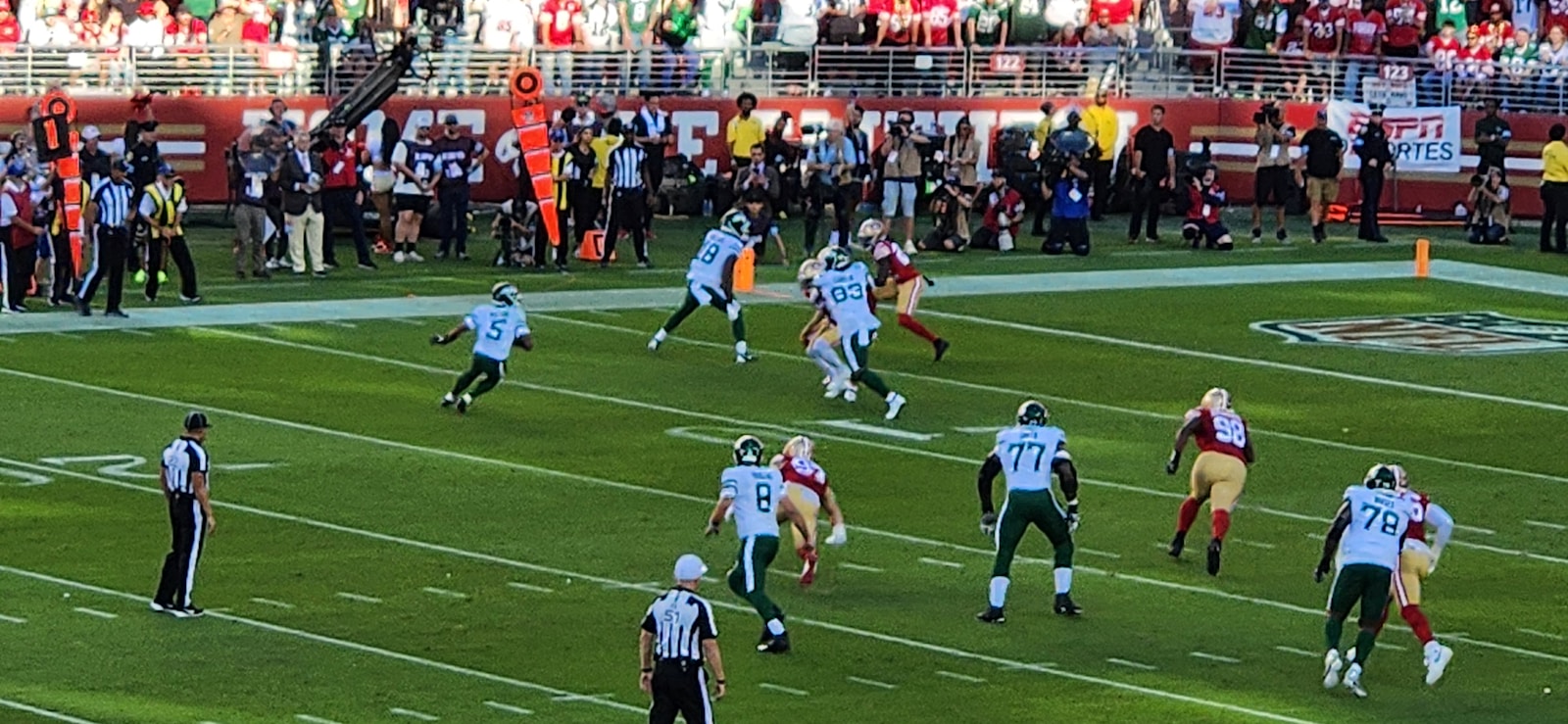 A group of people playing a game of football