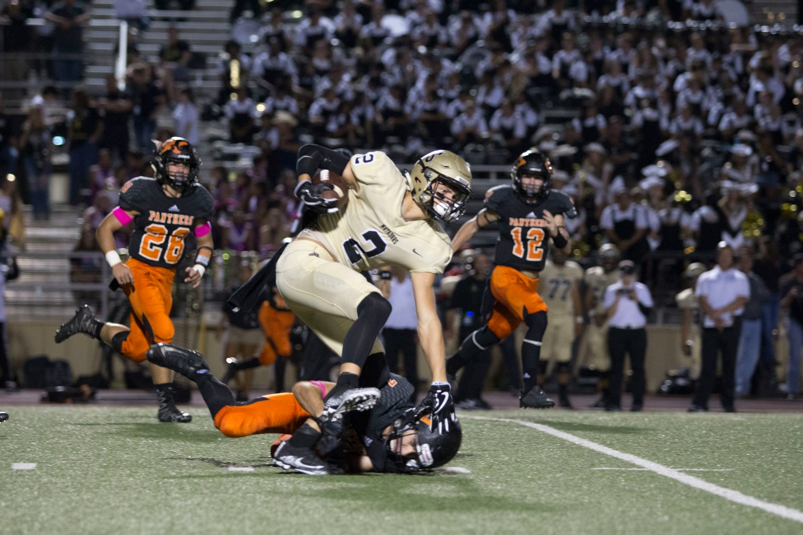 football player tackling another player in a match