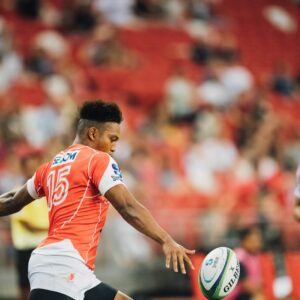 rugby player kicking rugby ball