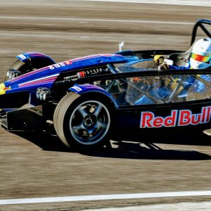 a man driving a race car on a track